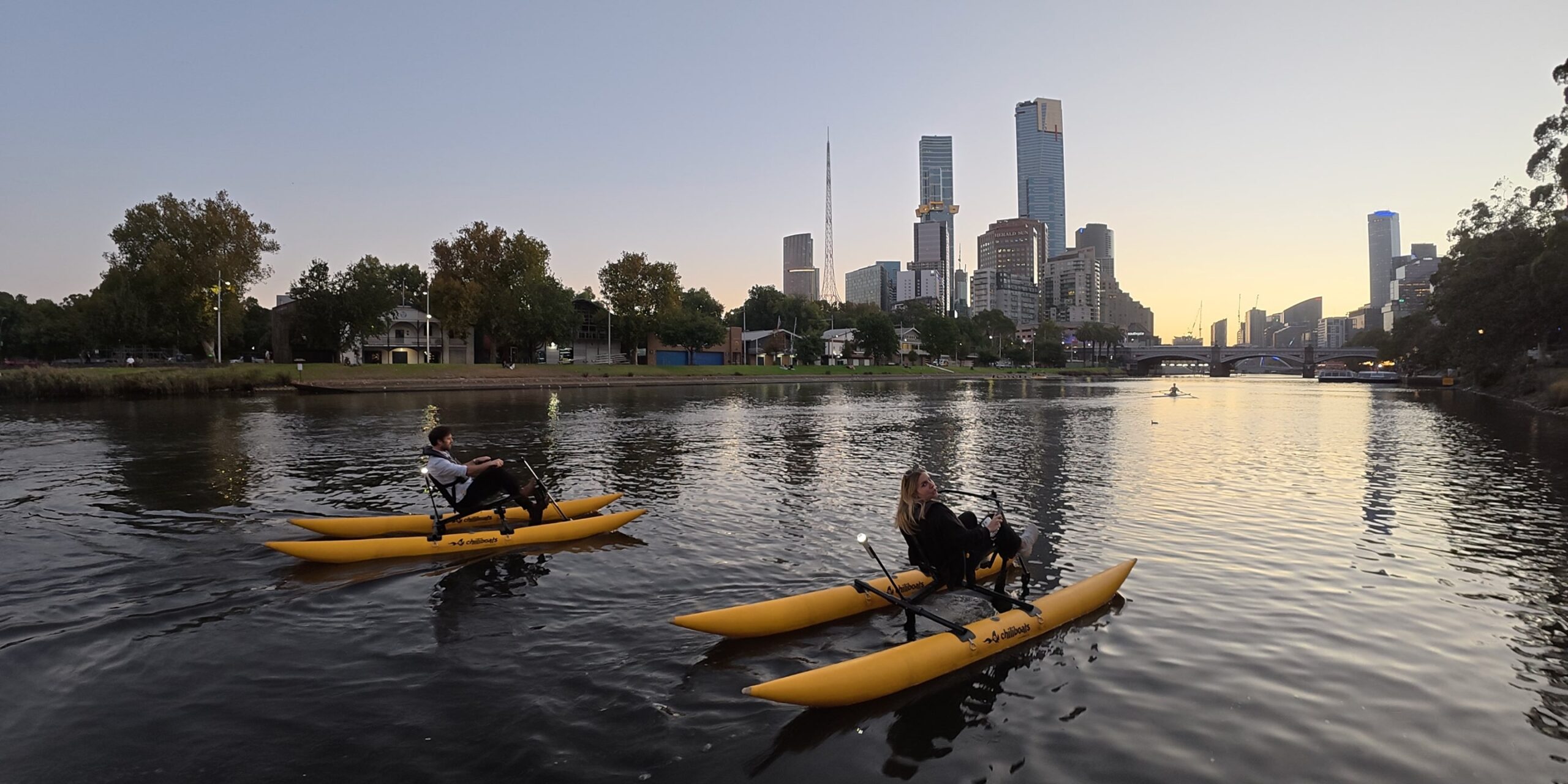 Group waterbiking on the Yarra River in Melbourne at twilight