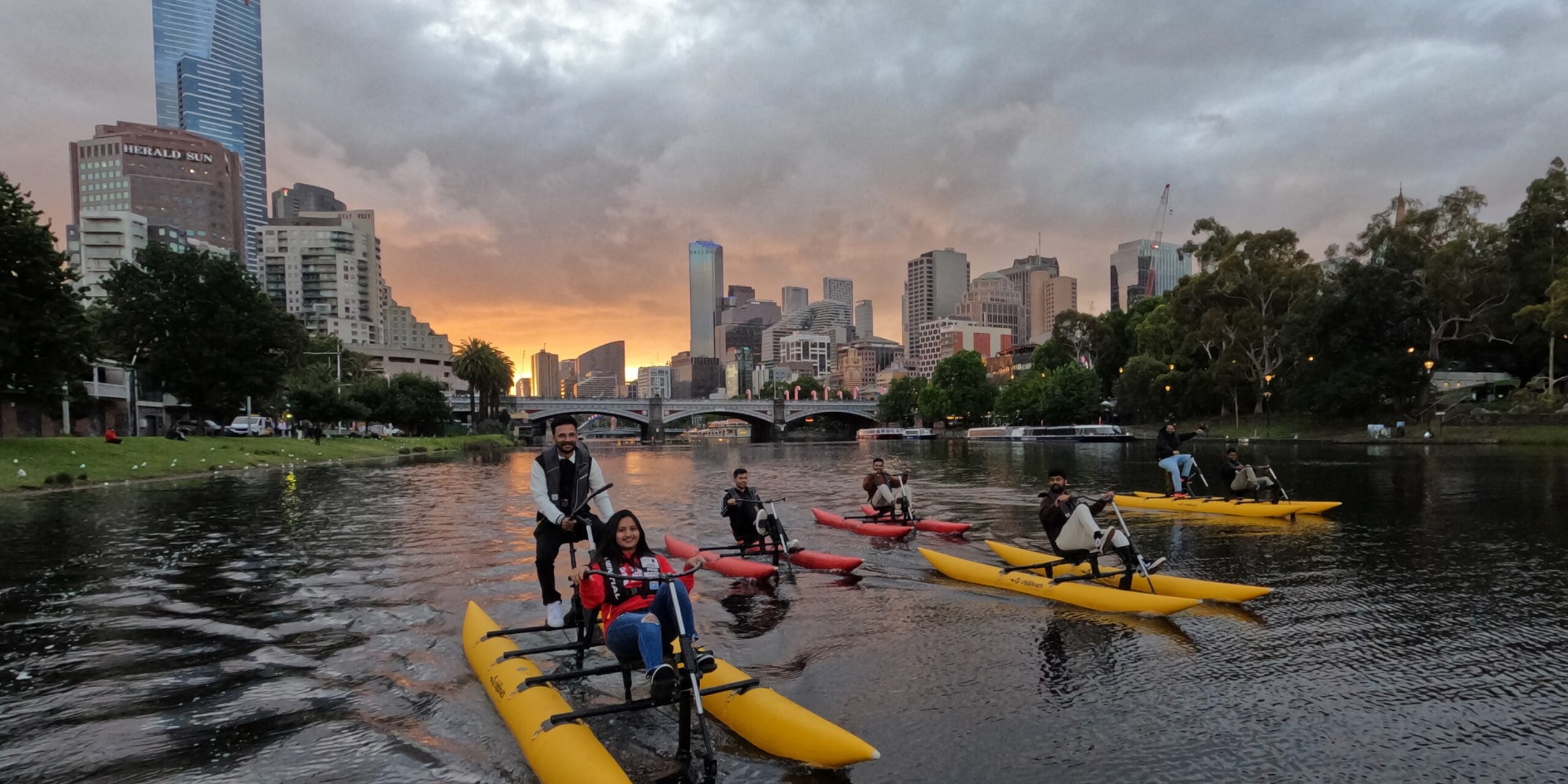 Group waterbiking on the Yarra River in Melbourne at twilight