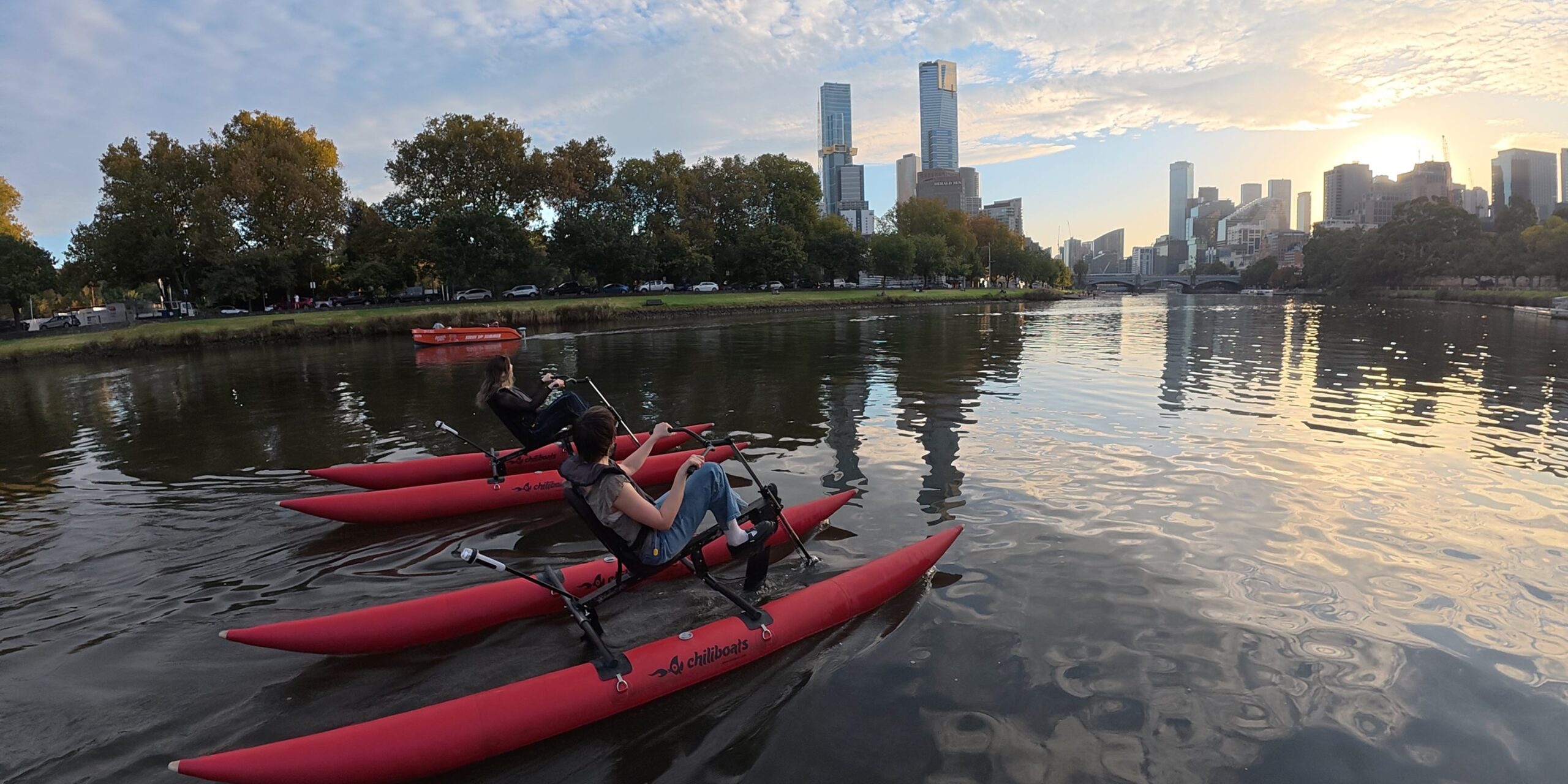Group waterbiking on the Yarra River in Melbourne at twilight