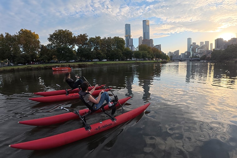 Group waterbiking on the Yarra River in Melbourne at twilight